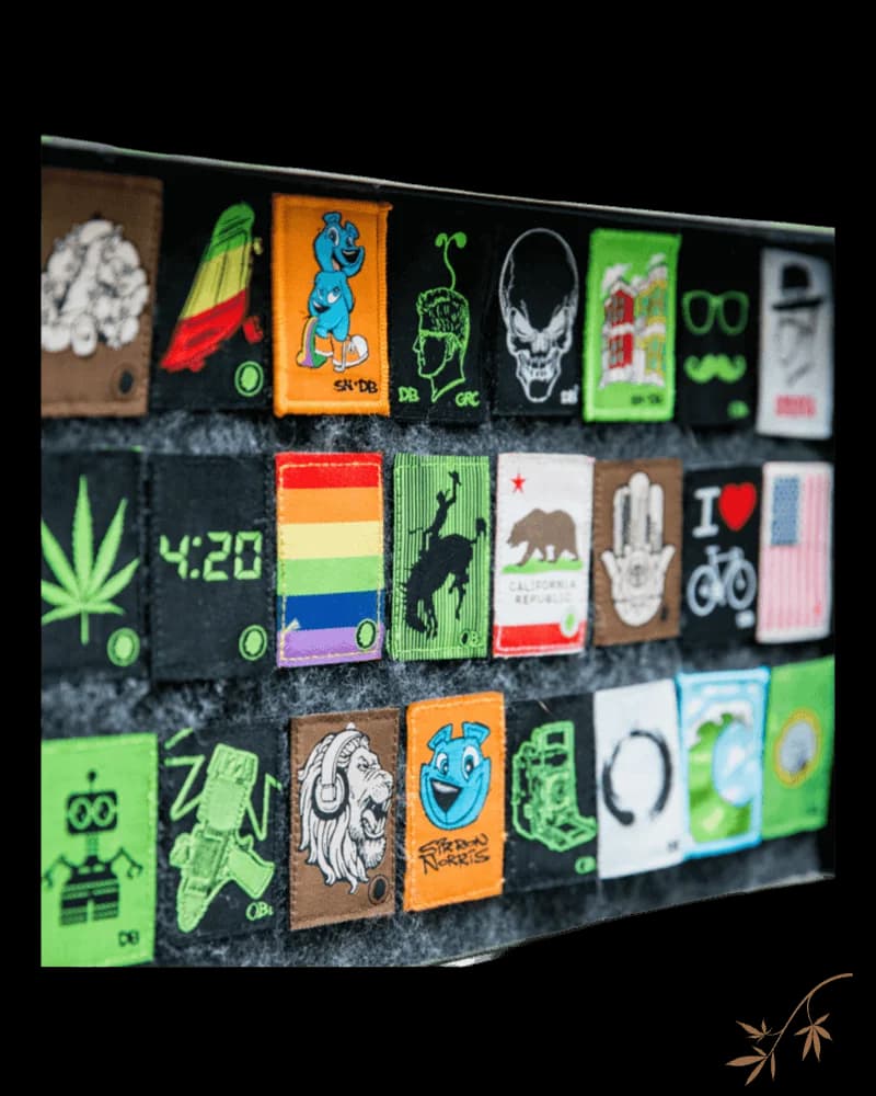 Dime Bags Velcro Patch collection display featuring colorful cannabis-themed patches including leaf, skull, rainbow, bear, and graphic designs on black backing