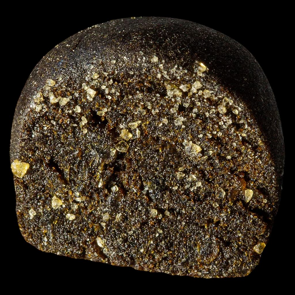 Jubilee Extracts Glitch Shatter-Hash cannabis concentrate with visible golden crystals and dark amber base
