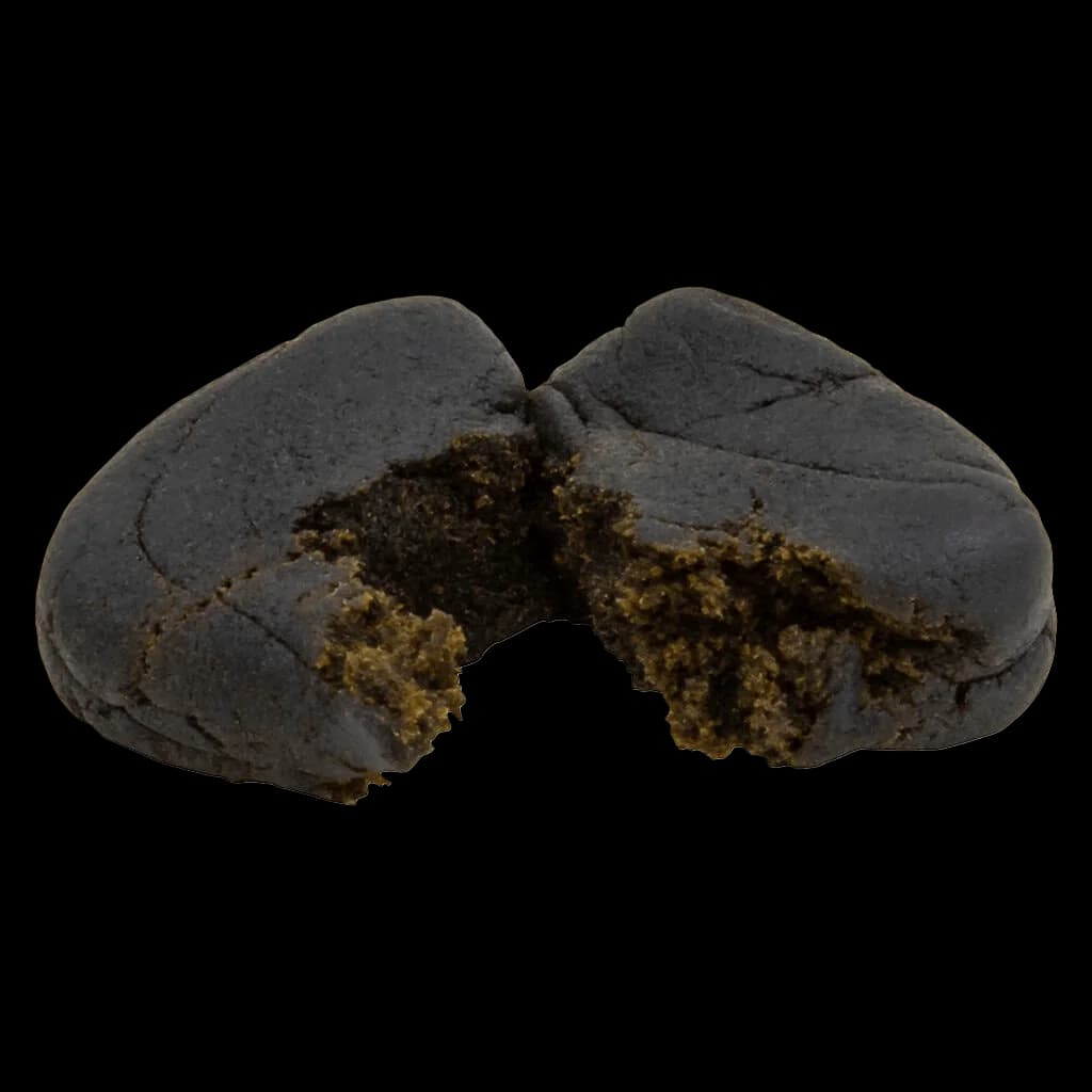 Thrifty Big Steal Infused Hash broken open to reveal olive-green interior cannabis concentrate