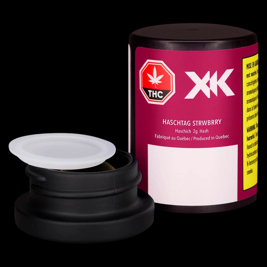 XK Haschtag Strawberry 2g cannabis hash in open black container with packaging