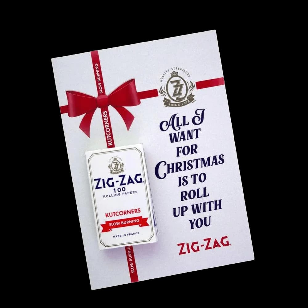 Zig-Zag 100 rolling papers kutcorners package with red ribbon bow and Christmas-themed promotional card