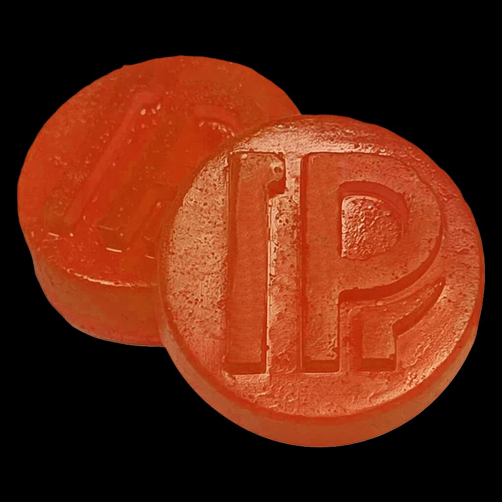 Pistol and Paris Orange Tingz live rosin gummies, two round orange soft chews with embossed branding
